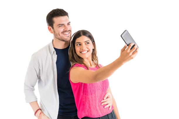istock Young Couple Clicking Memories Against White Background 1161081236