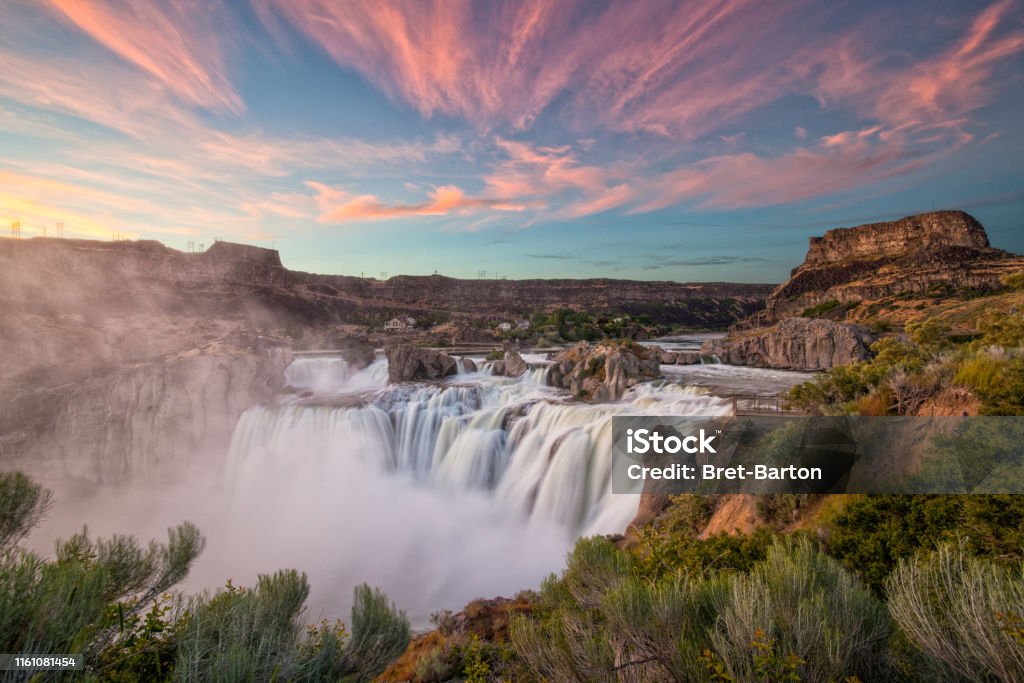 Shoshone Falls at Sunset The sky lights up at sunset over Shoshone Falls in Idaho. Shoshone Falls is considered the Niagara of the West. Idaho Stock Photo