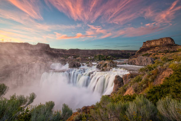Shoshone Falls at Sunset The sky lights up at sunset over Shoshone Falls in Idaho. Shoshone Falls is considered the Niagara of the West. golden hour photos stock pictures, royalty-free photos & images