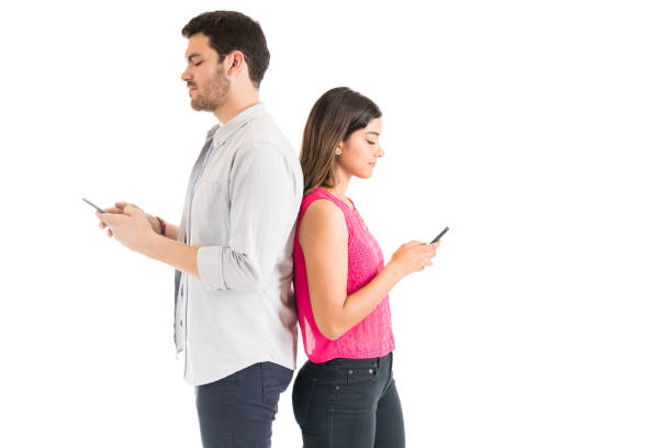 istock Distracted Man And Woman Using Cellphones Against Plain Background 1161081549