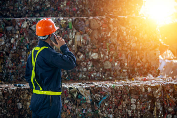 A man calling manager bottles pressed and packed for recycling A man calling manager bottles pressed and packed for recycling plastic pollution photos stock pictures, royalty-free photos & images