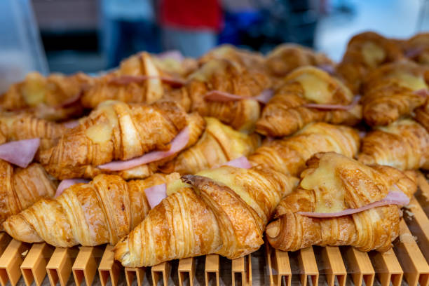 Pile of croissants with melted cheese and ham at bakery stock photo