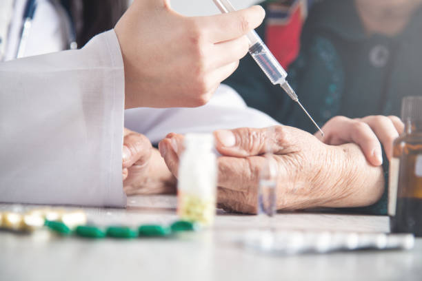istock Doctor making injection in elderly woman. 1161088538