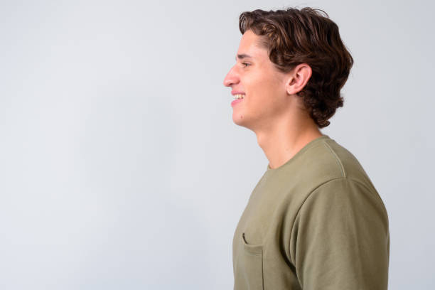 istock Young handsome man with wavy hair against white background 1161093350