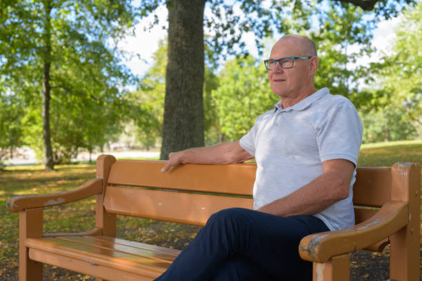 istock Handsome Senior Man Thinking While Sitting At The Park 1161094438