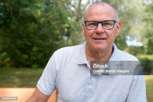 Face Of Handsome Senior Man Sitting At The Park Stock Photo - Download Image Now - Men, Portrait, Headshot