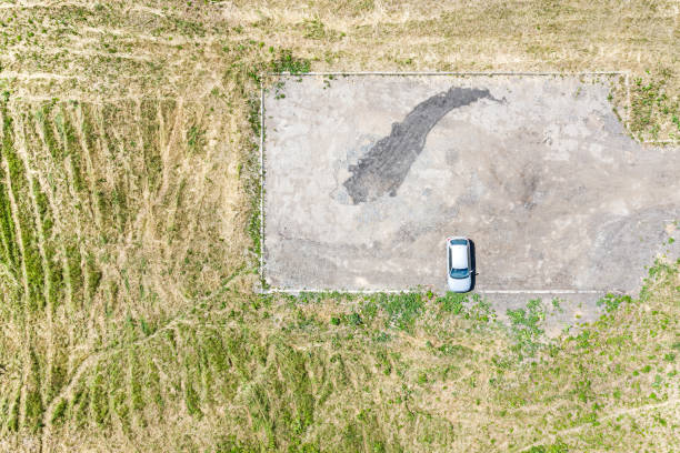 istock single car on empty parking lot. aerial view 1161094599