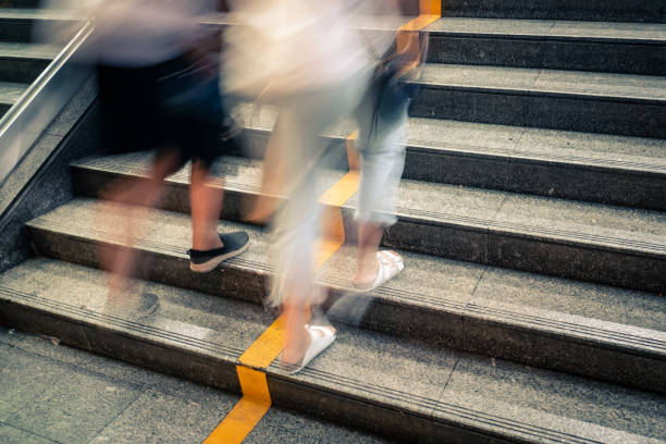 istock pedestrian walking upstairs with motion blur technique 1161097384