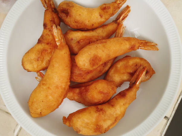 A plate of cooked fried prawn with tempura flour