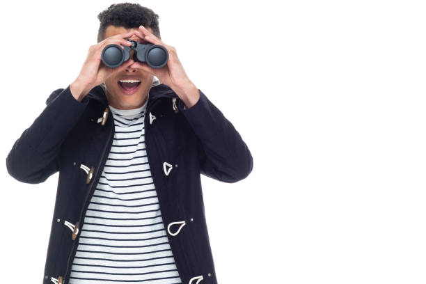 istock Handsome black man with curly hair and wearing a jacket - binoculars 1161098979