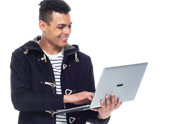 istock Handsome African American male standing on white background - using a laptop 1161099488