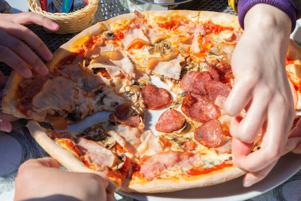 istock pizza with pepperoni, salami, pepper, cheese, close-up. 1161111575