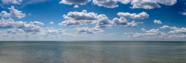 istock white clouds float in the blue sky over the sea 1161111743