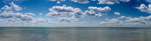 istock white clouds float in the blue sky over the sea 1161111789