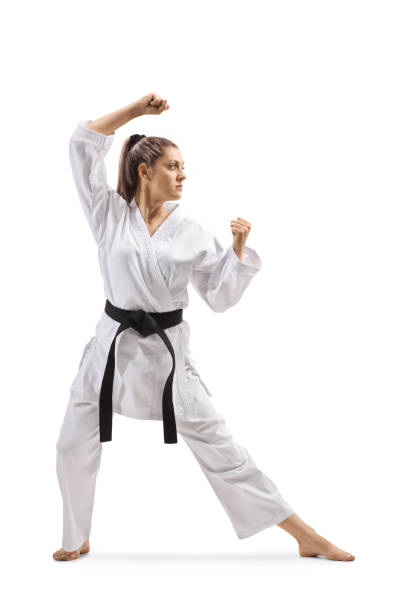 istock Woman with black belt and kimono practicing karate kata 1161113160