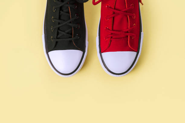 istock New red and black sneakers on yellow background with copy space. 1161114696