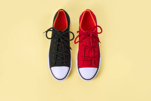 istock New red and black sneakers on yellow background with copy space. 1161114704