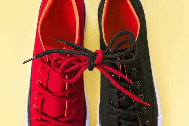 Red sneakers on a dark marble background. Footwear for outdoor activities