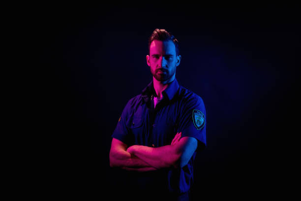 istock Handsome man on black background with red and blue lighting 1161115334