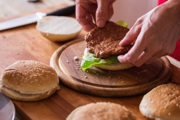 istock Hamburger preparing, meat steak at burger bun, close-up 1161120274