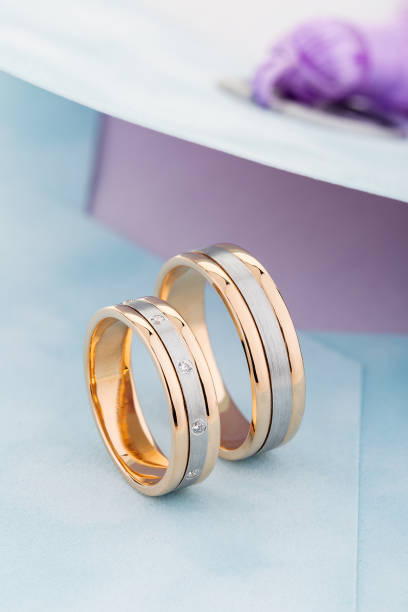 istock Silver and gold wedding rings band with gemstones on blue envelope 1161120402