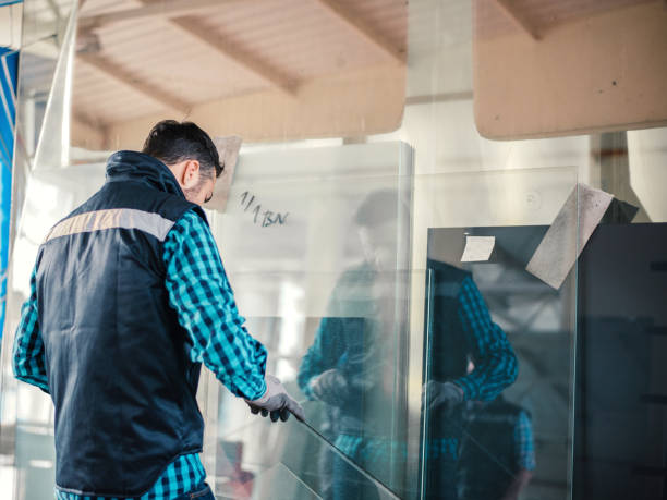 istock Worker handling glass sheet in warehouse 1161122106