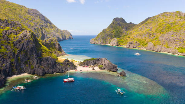 istock Rocky coast with a white beach. Tropical island with jungle 1161124229