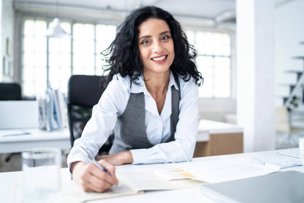 istock Businesswoman working in office, signing documents 1161124350