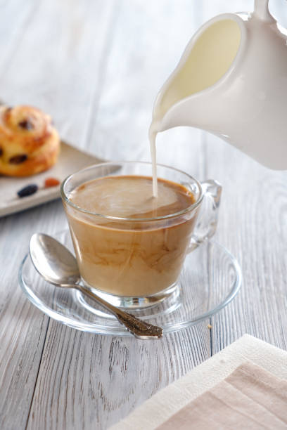 istock Delicious and crispy croissants with coffee on a white wooden table 1161125917