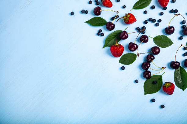 istock Ripe berries on a blue wooden background. 1161126813