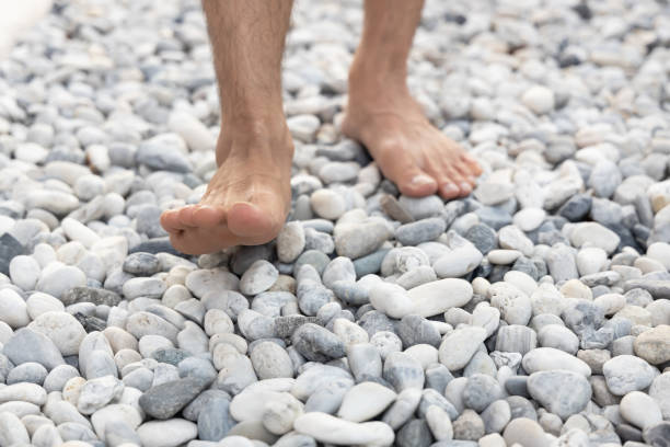 Foot massage of young man with stone and  Relaxing for life, natural therapy concept