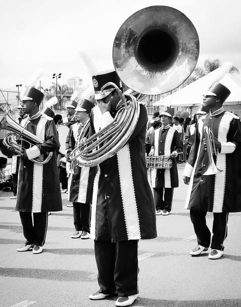 On a sunny afternoon, a young trombonist pauses to breathe during a fanfare festival parade celebrating the town's birthday. Mogi das Cruzes, Brazil, September 01, 2018