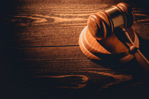 istock Wooden judge gavel hammer on wooden table background. Dramatic light. Copy space 1161128498