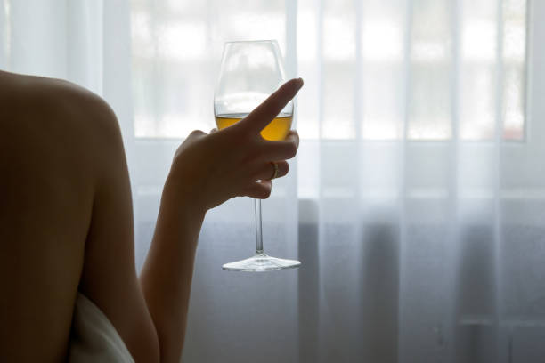istock Glass with alcoholic drink in female hand 1161128558