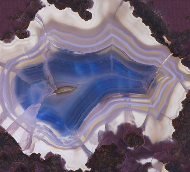 istock Translucent blue  slice of natural stone agate. Natural concentric patterns and textures of minerals for background. 1161129388