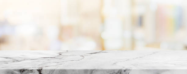 istock Empty white marble stone table top on blurred with bokeh cafe and restaurent interior banner background - can be used for display or montage your products 1161130005