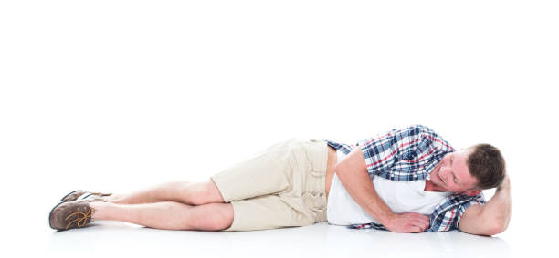 istock Handsome man in shirt and shorts is lying down and relaxing 1161130463