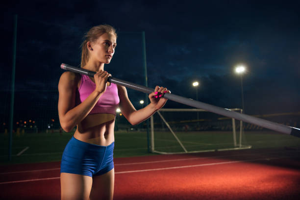 istock Female pole vaulter training at the stadium in the evening 1161131399