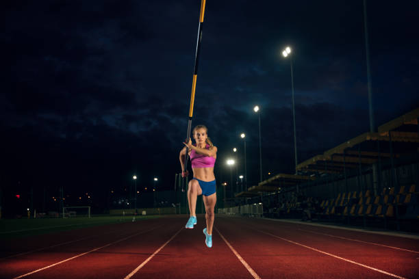 istock Female pole vaulter training at the stadium in the evening 1161131464
