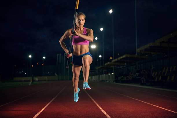 istock Female pole vaulter training at the stadium in the evening 1161131473