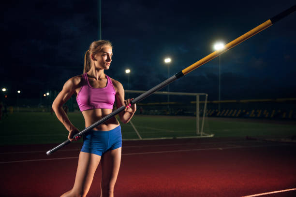 istock Female pole vaulter training at the stadium in the evening 1161131492