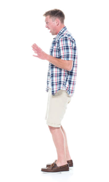 istock Handsome man in shirt and shorts is sad, side view 1161132554