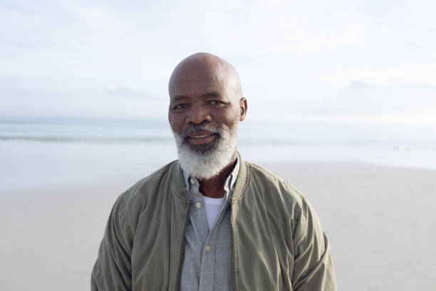 istock African-American man smiling by the beach 1161134160
