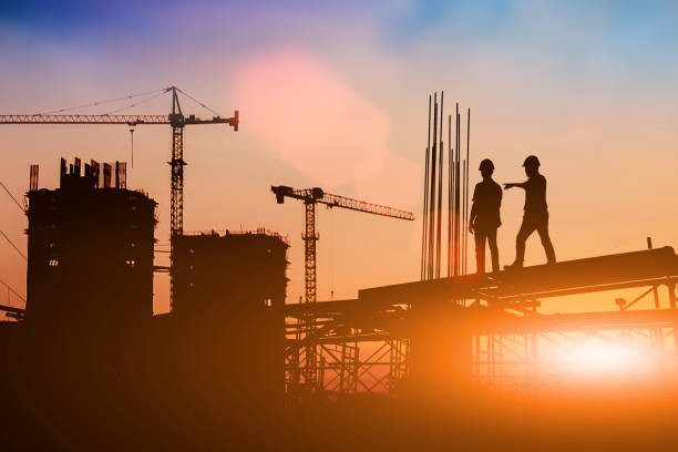 istock Silhouette of engineer and construction team working at site over blurred background for industry background with Light fair.Create from multiple reference images together 1161137063