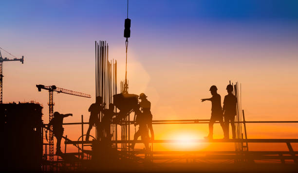 istock Silhouette of engineer and construction team working at site over blurred background for industry background with Light fair.Create from multiple reference images together 1161137065