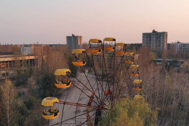 City of Pripyt near Chernobyl nuclear power plant Ferris wheel in the City of Pripyat at sunset time. Apocalyptic city of Pripyat after a nuclear explosion at a nuclear power plant. Rusty carousel in the amusement park of the city of Pripyat. pripyat city stock pictures, royalty-free photos & images