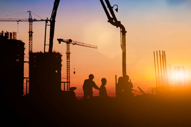 istock Silhouette of engineer and construction team working at site over blurred background for industry background with Light fair.Create from multiple reference images together 1161137262