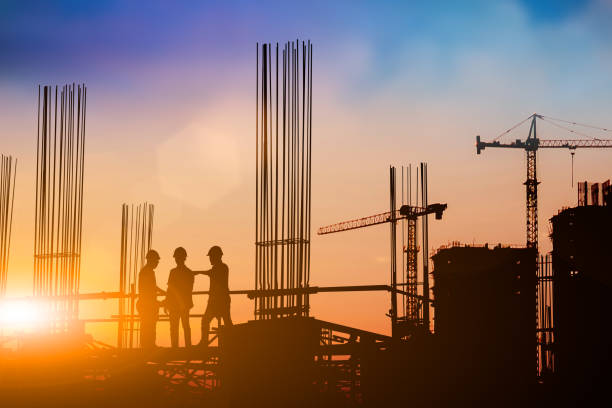 istock Silhouette of engineer and construction team working at site over blurred background for industry background with Light fair.Create from multiple reference images together 1161137267