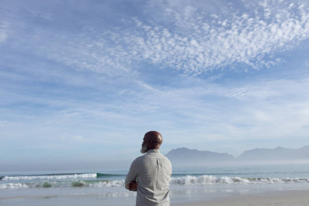istock Man gazing at the beach. 1161138506