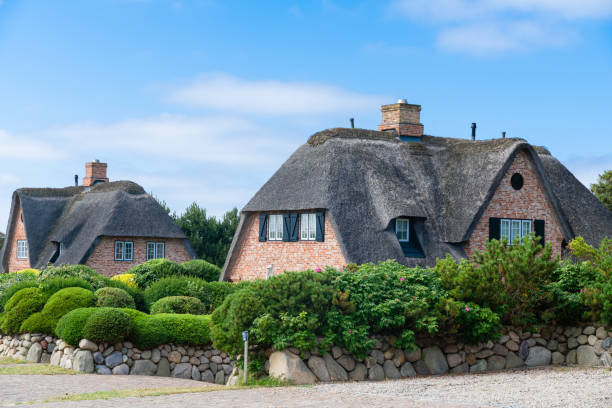 Kampen-Sylt, Germany, June 28 2019: Thatched Roof ( Reetdach ). Typical house with straw roof in small village on Sylt island in  Germany.